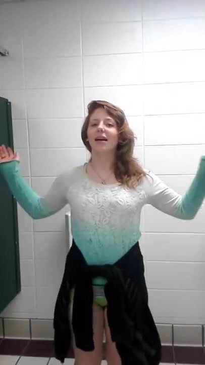 Girl pee in urinal.