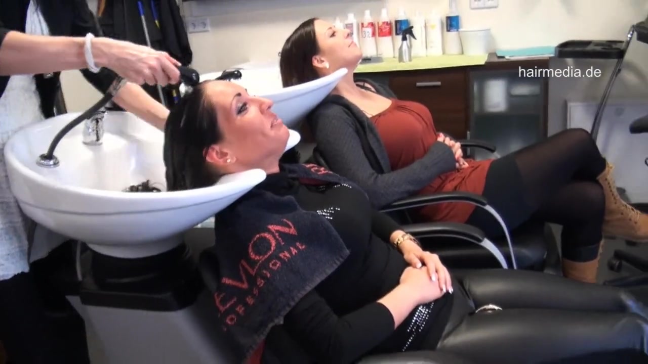 Beatiful woman washing hair forward in a salon.